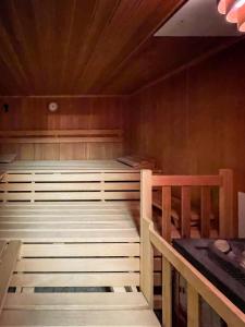 a sauna with two beds and a wooden ceiling at Haus Sabine in Leutasch