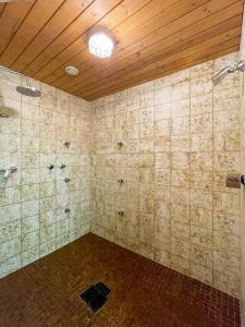 a tiled bathroom with a shower and a ceiling at Haus Sabine in Leutasch +27 photos