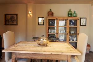a dining room table with a china cabinet at Casa Sullà in Tremp