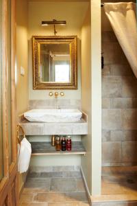 a bathroom with a tub and a sink with a mirror at Casa Rural Sullà in Tremp