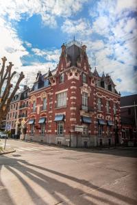 a large red brick building on the side of a street at MAISON RENARD in Béthune