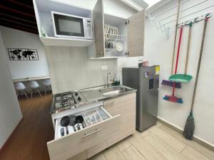 uma pequena cozinha com um lavatório e um frigorífico em HERMOSO APTO EN LAURELES em Medellín
