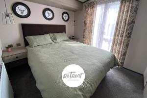 a bedroom with a large bed with clocks on the wall at ReTreat Breaks - 47 Park Lane in Patrington