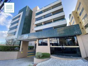 a large building with a building at Flat Luxuoso-Piscina, Praia e Serviço de Camareira in Salvador +4 photos