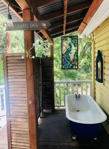 a bathroom with a bath tub on a porch at Flume's End in Nevada City