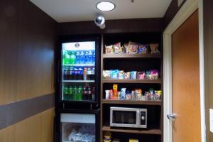 a refrigerator with drinks and a microwave in a room at Fairfield Inn Indianapolis South in Indianapolis