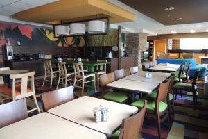 a dining room with tables and chairs in a restaurant at Fairfield Inn Indianapolis South in Indianapolis