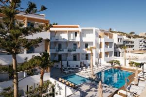an aerial view of a building with a swimming pool at Petradi Beach Lounge Hotel by GHH in Rethymno