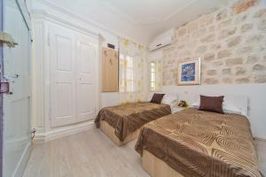 Ένα ή περισσότερα κρεβάτια σε δωμάτιο στο Apartments & Rooms Orlando