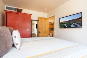 Schlafzimmer mit einem Bett und einem TV an der Wand in der Unterkunft El Corazon 12 in Santa Fe