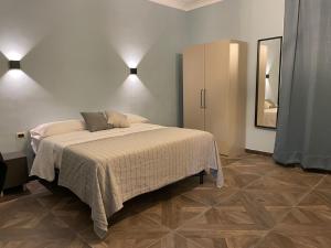a bedroom with a large bed and a mirror at Metrodante in Naples