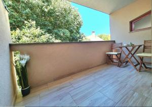 a balcony with a wooden floor and a wall at Apartments Beleca in Biograd na Moru