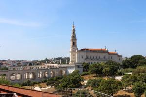 un grande edificio con una torre in cima di Apartamento Fátima Sanctuary a Fátima