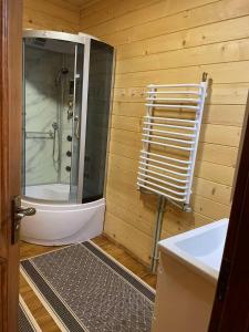 a bathroom with a shower and a toilet and a sink at Sweet Home in Krasnyy