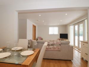 a living room with a table and a couch at The Winning Post in Bruton