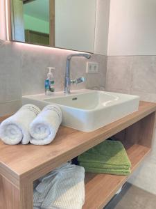 a bathroom with a sink and towels on a counter at Appartements Blumenwiese in Ramsau am Dachstein