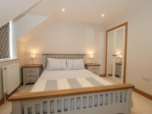 a bedroom with a large bed with two night stands at The Final Furlong in Bruton