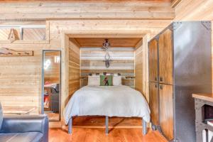 a bedroom with a bed in a wooden cabin at Wy'east Nest in Government Camp