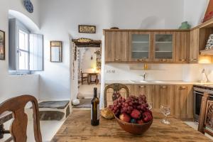 a kitchen with a bowl of fruit on a table at Old Mansion in Melanes in Mélanes