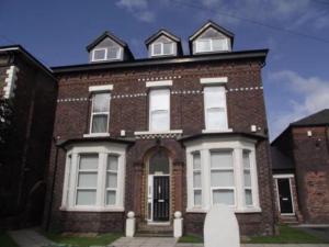 a brick house with three windows on top of it at Beautiful 2 bedroom apartment - close to beach in Waterloo