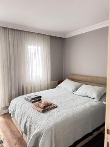 a bedroom with a bed with a towel on it at an apartment in a decent neighborhood in Karşıyaka