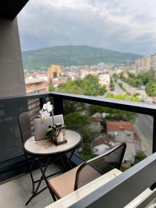 a table with a cake on top of a balcony at Maria's Elite Luxury Apartment Skopje in Skopje