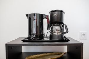 a counter with a coffee maker and a coffee pot on it at Apartmani Ana & Milo in Lopar