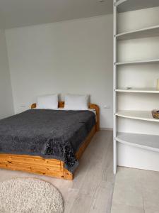 a bedroom with a bed and shelves at Квартира студіо in Luts'k
