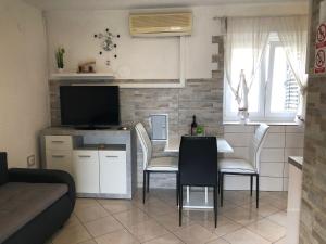 a kitchen and living room with a table and chairs at Old city core in Senj