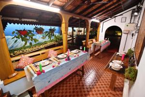 a restaurant with a table with plates of food at The Beach Cottage Kappad in Kozhikode