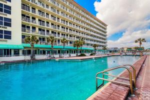 a large swimming pool in front of a hotel at The Ocean Calls, Unit #612 in Daytona Beach