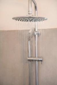 a shower with water pouring out of it at Afluencia Complex Studio No 4,5,6 in Naousa