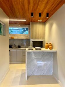a large kitchen with a marble counter top at Lencóis Ville Residence in Barreirinhas