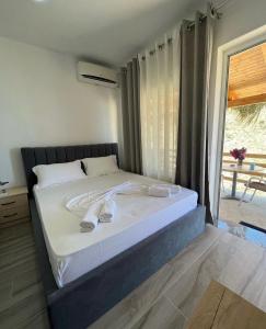 a bedroom with a bed with towels on it at Vila Orizzonte blue in Sarandë +80 photos
