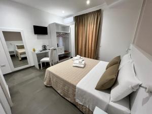 a hotel room with a bed and a desk and a room at Anfitrite B&B Tropea in Tropea