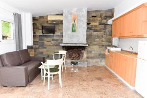 a living room with a couch and a fireplace at Barreira Beachfront Room 1 in Verga Kalamata