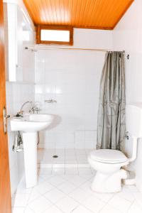 a bathroom with a toilet and a sink at Barreira Beachfront Room 1 in Verga Kalamata +28 photos