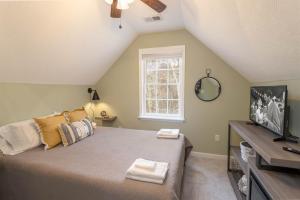 Un dormitorio con una cama y un televisor y una ventana. en Whiskey Ridge, en Boone