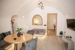a living room with a bed and a table at Luxury Canava in Emporio