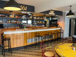 a bar in a restaurant with bar stools at Hotel du Luxembourg in Balsièges