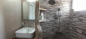 a bathroom with a sink and a shower at Summer House Paliochori in Paliochori