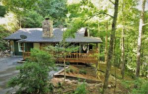 a house in the middle of the woods at Lakeside Mountain Oasis - 3 Bedroom Cabin with Outdoor Hot Tub in Topton