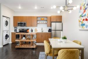 a kitchen and dining room with a table and a refrigerator at Fun & trendy condo close to downtown and the beach in Traverse City