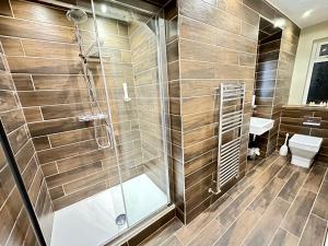 a bathroom with a shower and a toilet at Birches Brow Boutique Guest Rooms in Aughton