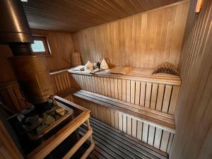 an inside view of a wooden sauna at Unique Mailo House & Cottage in Riga +37 photos