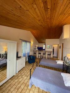 a bedroom with two beds and a wooden ceiling at Residence VILLA MOROSI - Favone in Conca +71 photos