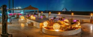 a patio with lights and a gazebo at night at Desert Moon in Cairo