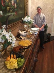 a man is standing next to a buffet of food at The Lasker Inn in Galveston