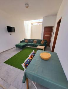 a living room with a green table and a couch at Iknews Appart Dakar in Kammba
