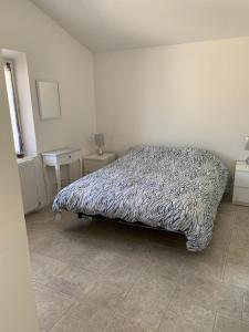 a bedroom with a bed and a table with a lamp at Terre de Lumière in Nyons +21 photos